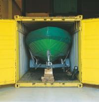 A boat stored in a container in a warehouse